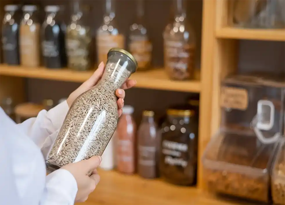 Glass bottle filled with seeds.