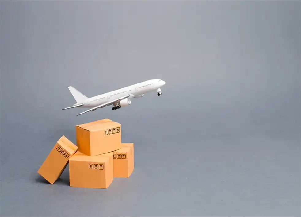 Toy airplane taking off from cardboard boxes.